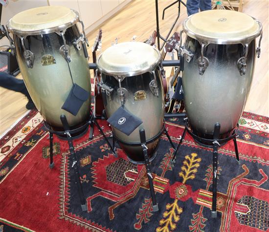 Three Pearl Elite fibreglass congas with basket stands